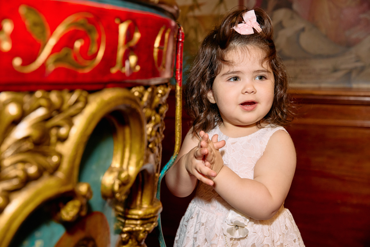 Little girl standing by the baptism fountain.