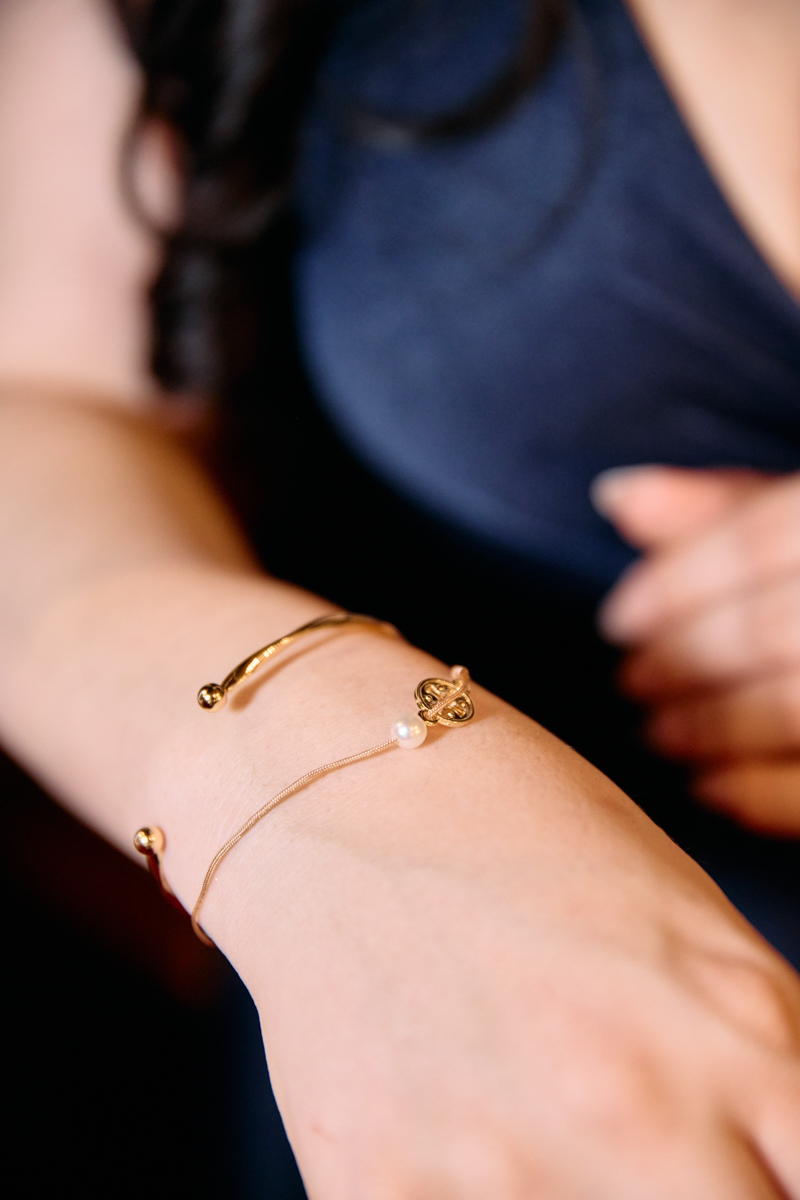 A christening bracelet on a woman's hand.