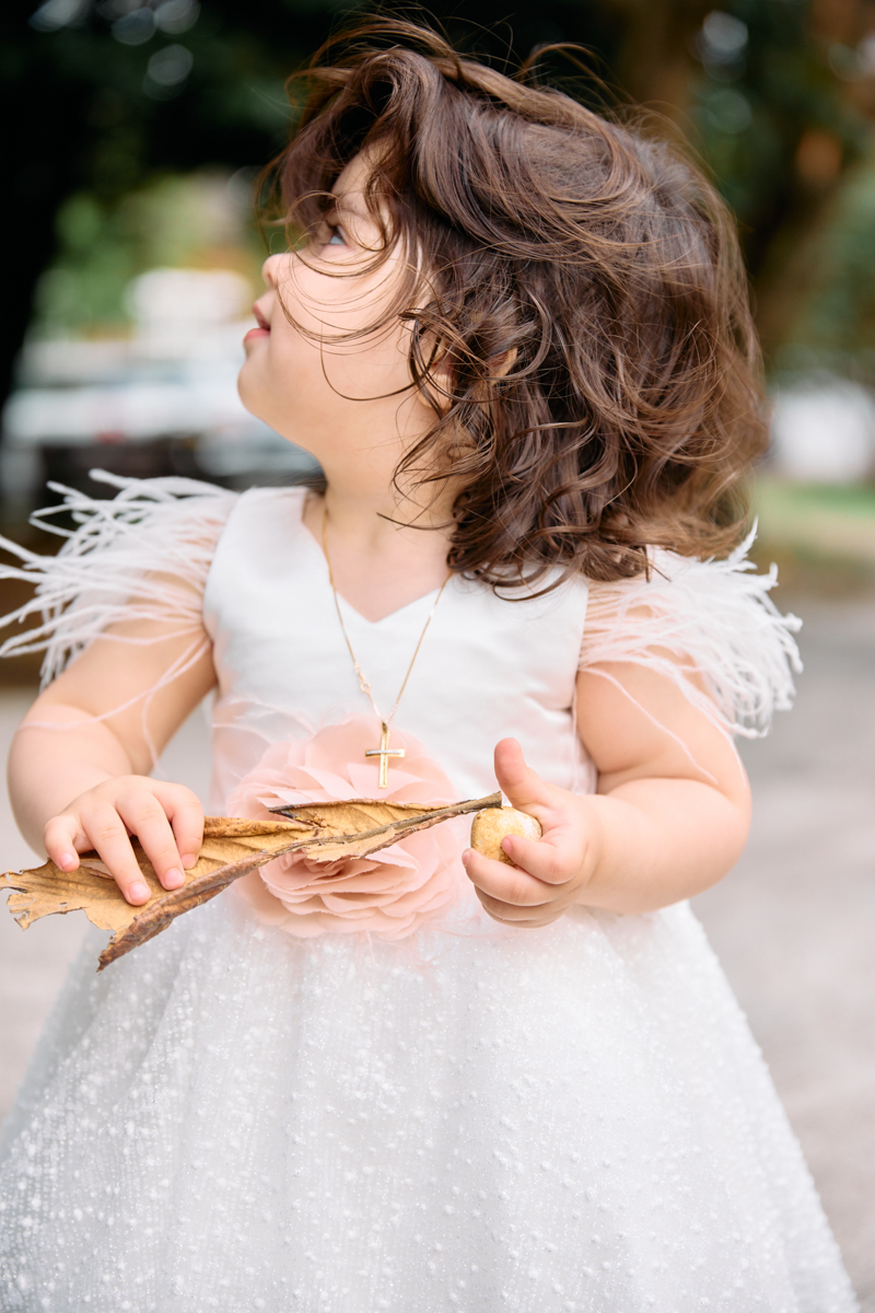 Little girll in her new christening dress after her christening outside the church.