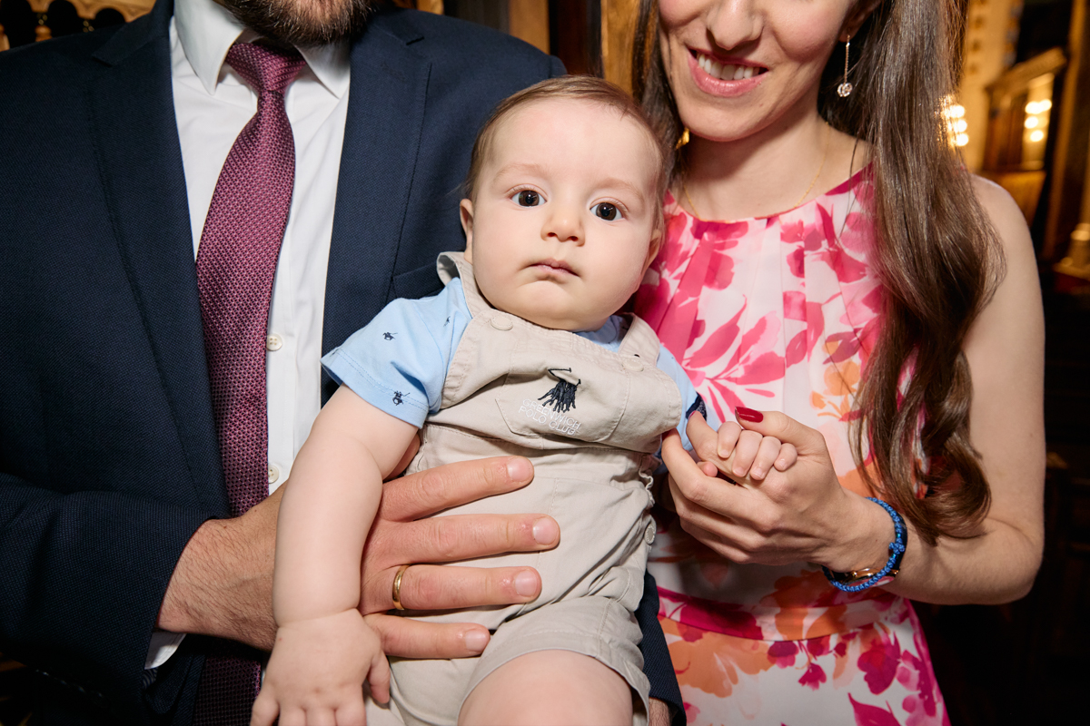 Close-up of parents holding the baby.