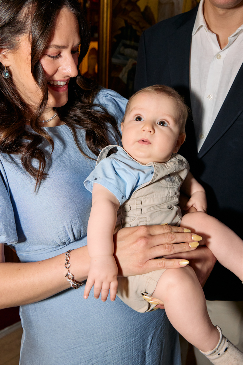 Godmother holding the baby while another family member stands close.