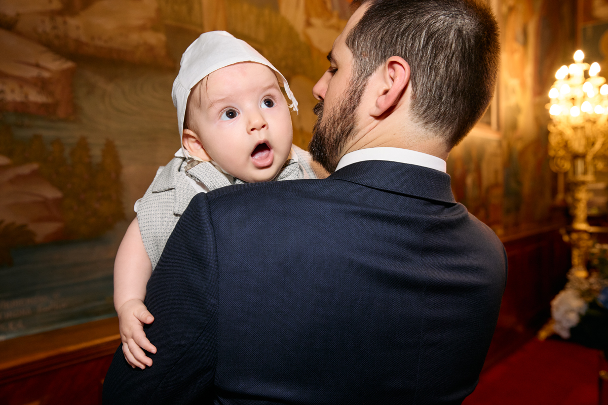 Father holding the baby close during the service.