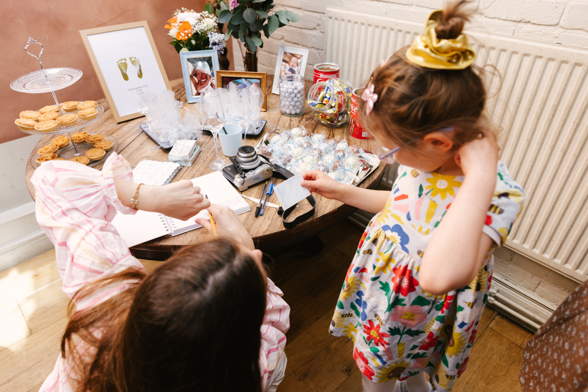 Young girl decorating pages at the reception table.