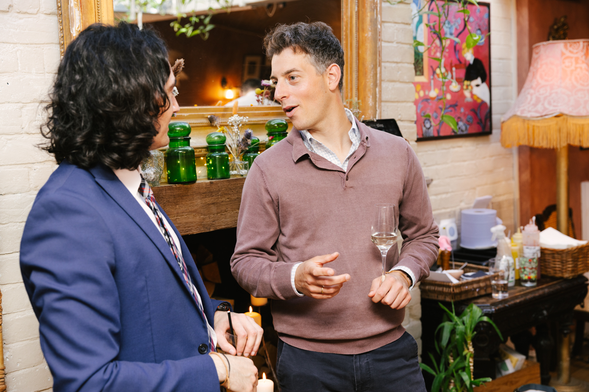Group of guests chatting and holding drinks.