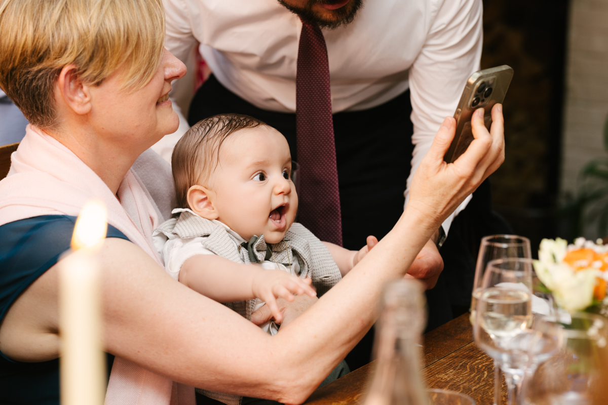 Family member taking a selfie with the baby.