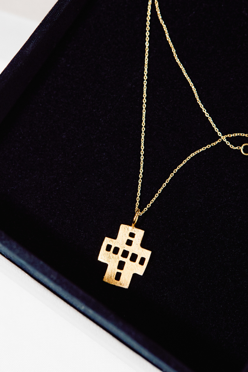 A golden crucifix in a presentation box.