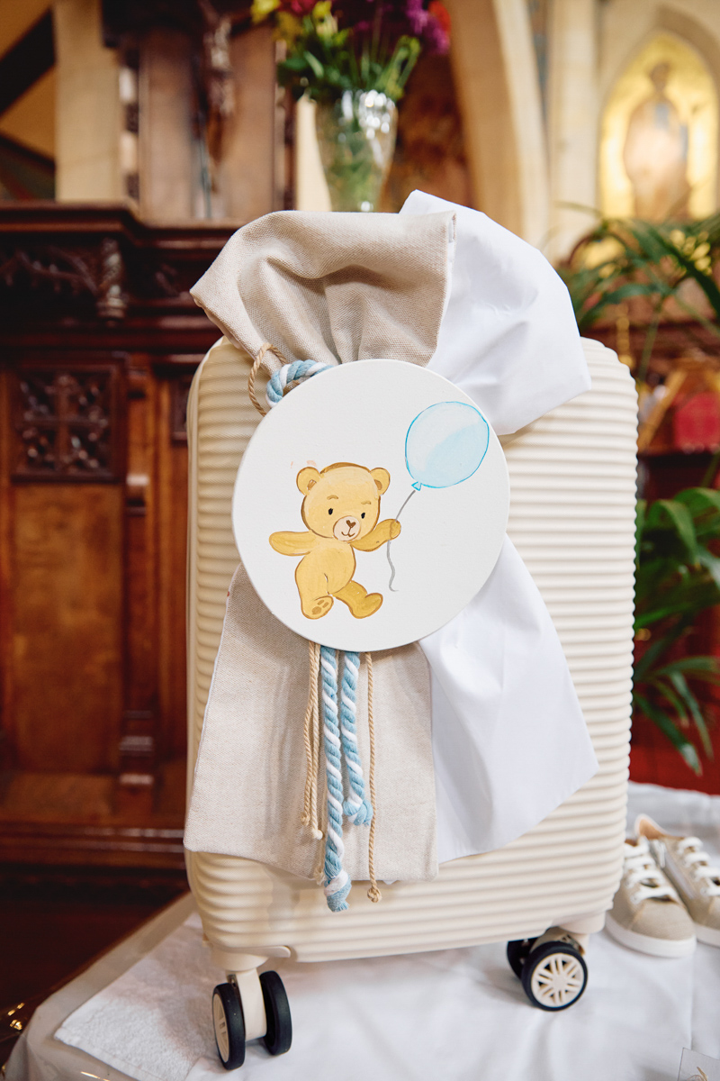 A suitcase for christening clothes on the table of a church.