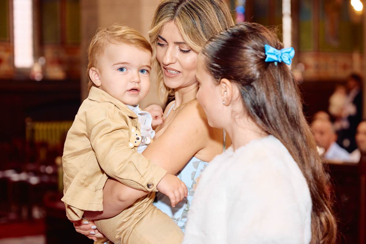Mum holding her little boy after the christening.