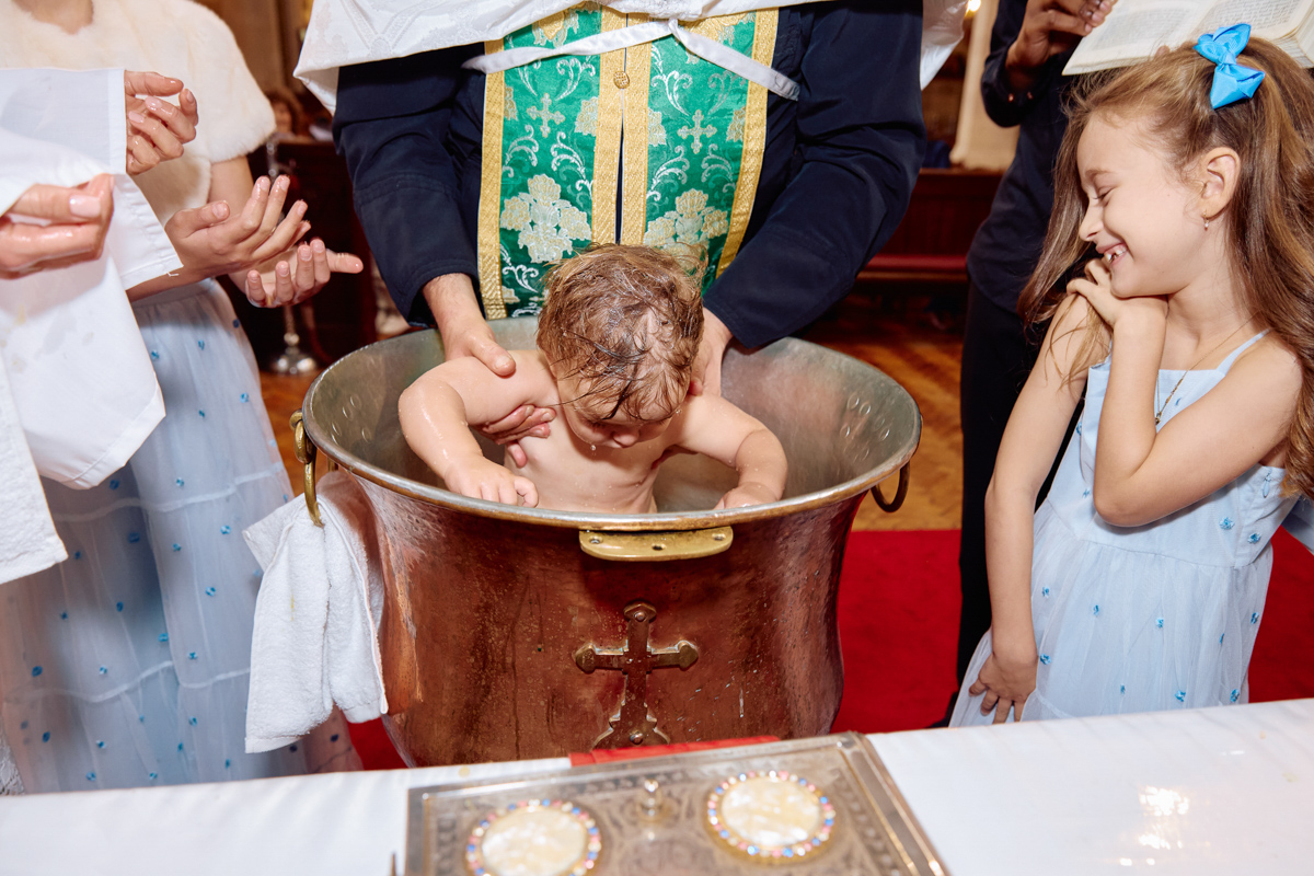 Little boy being christened.