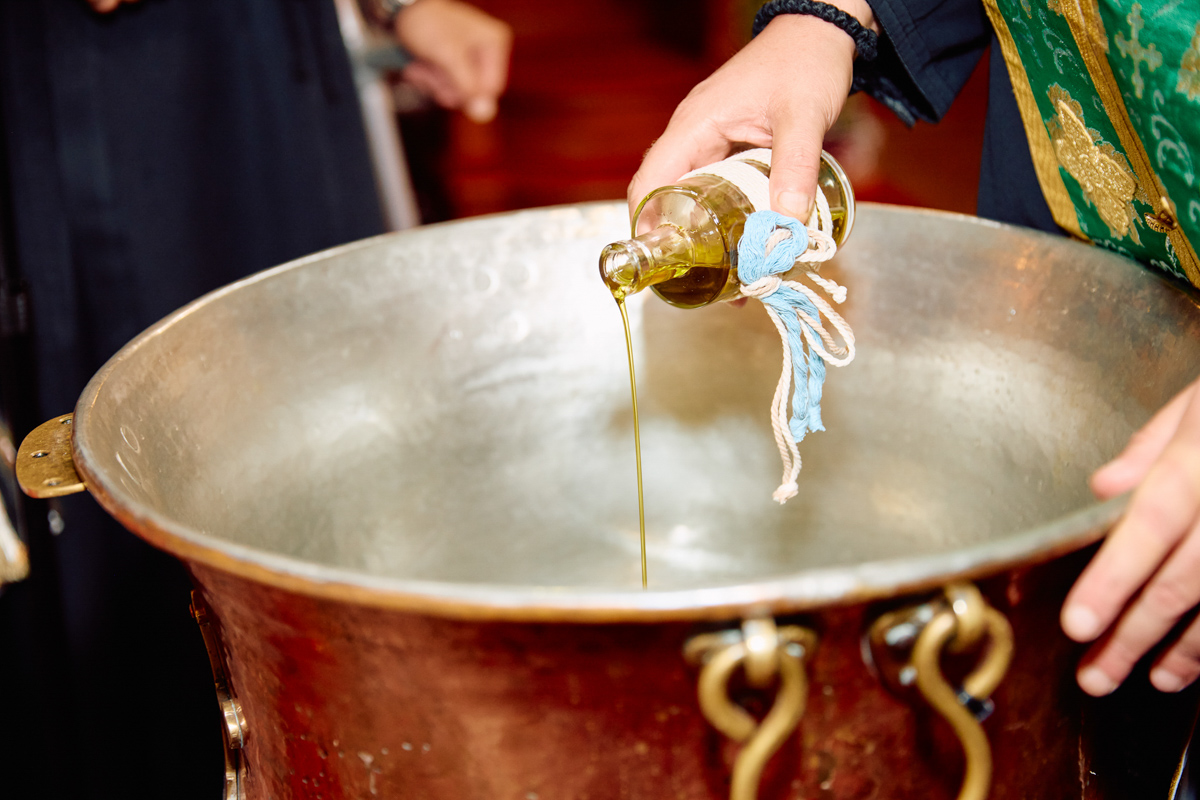 Sacred oil poured in the christening font.