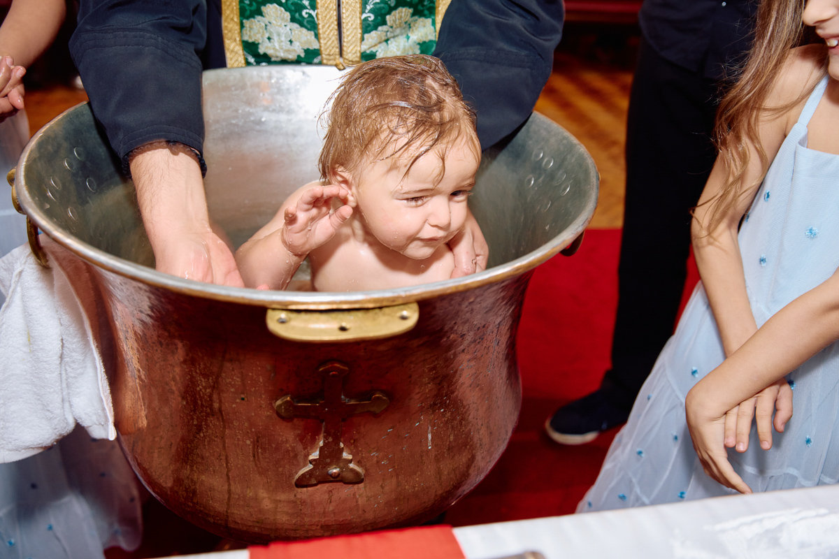 Little boy being christened.