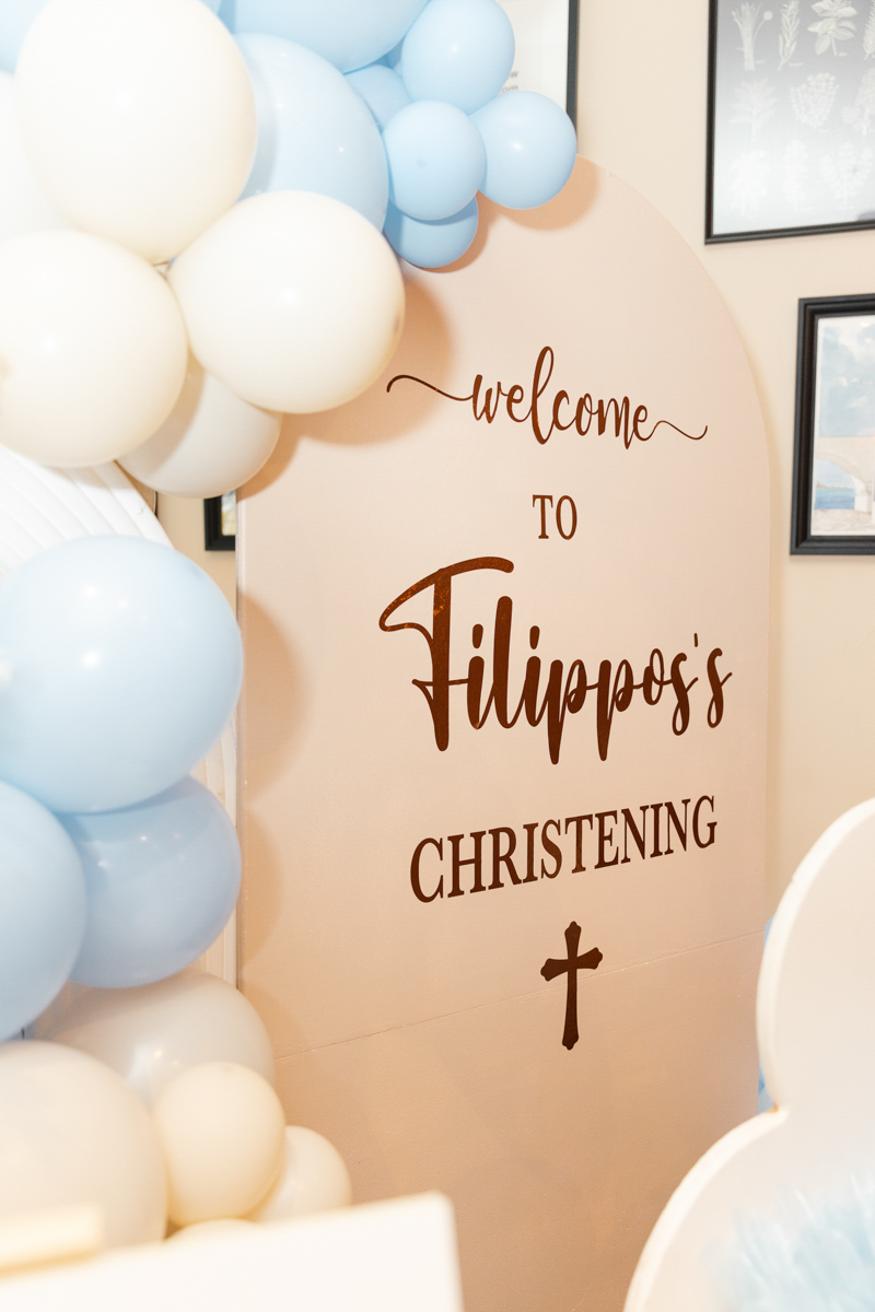 Party decorations, balloons and a sign with the baby's name on it.
