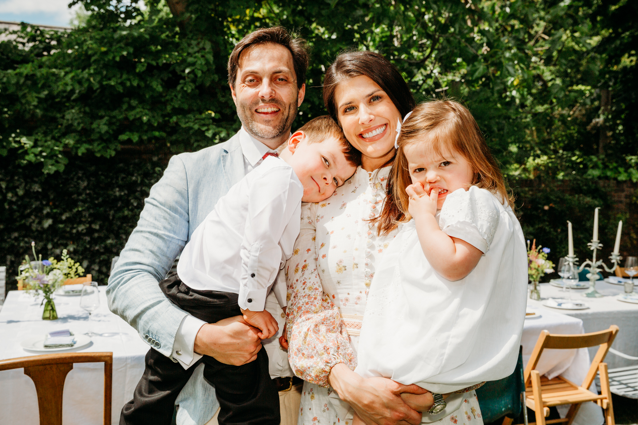A family posing for a photo in their garden.