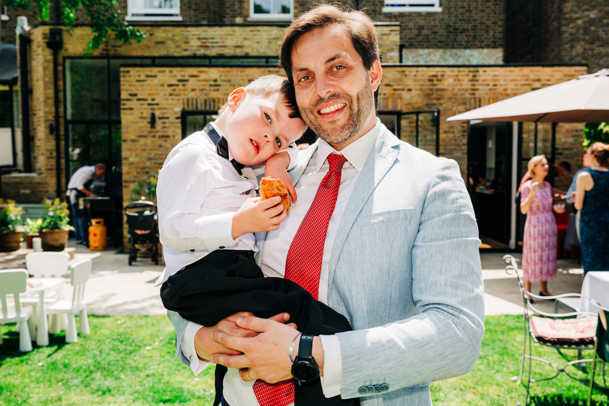 Dad and son smiling at the camera.