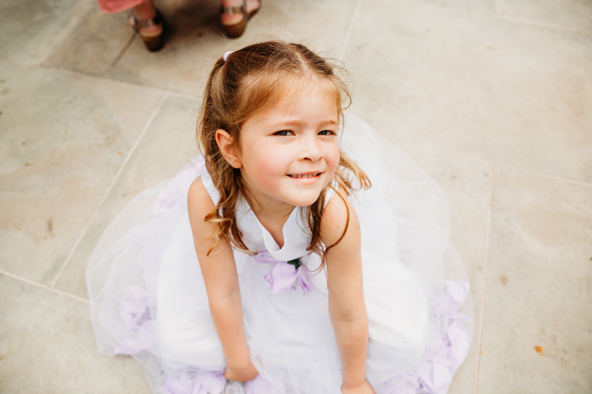 A little girl looking up at the camera.