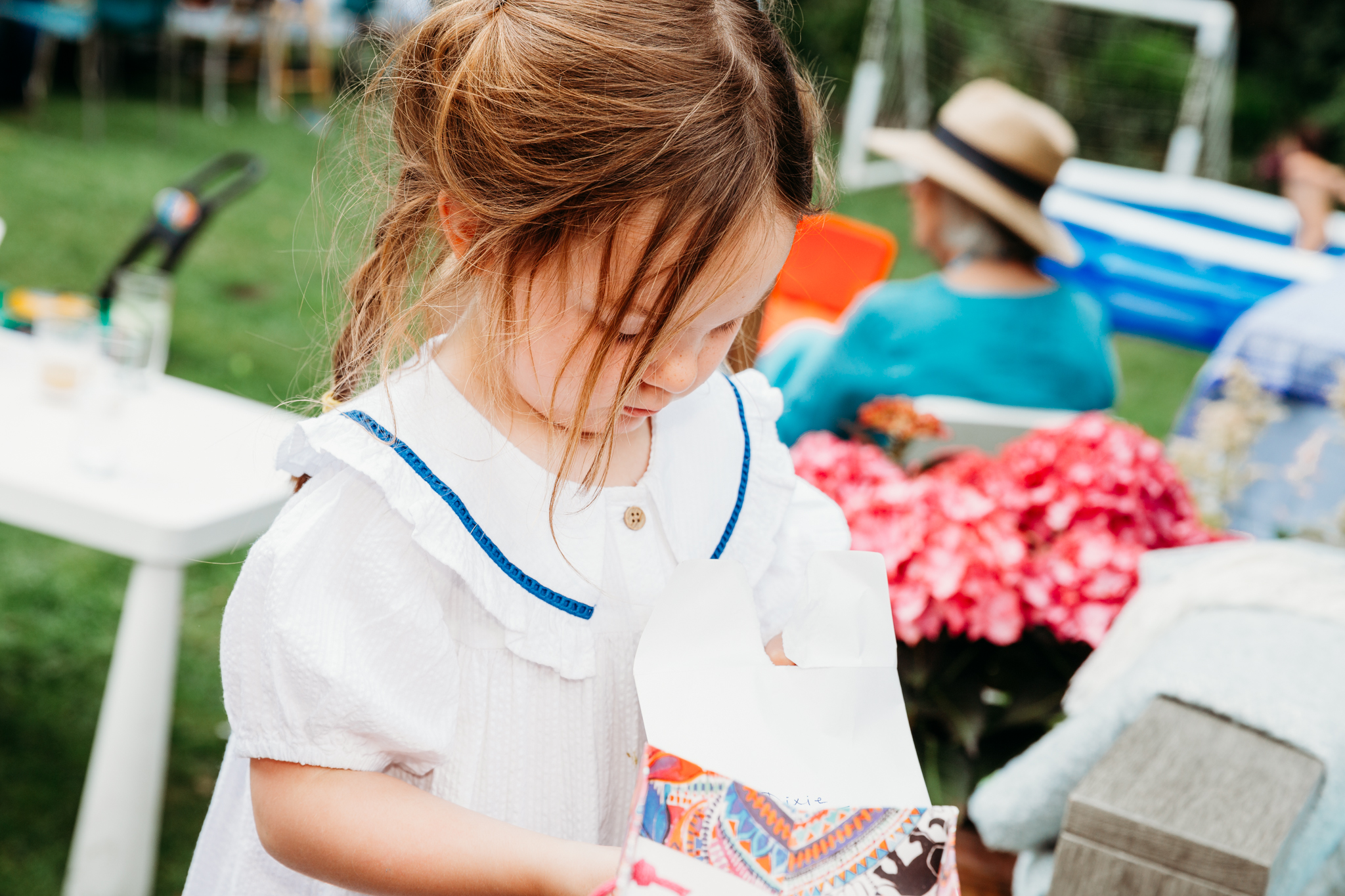 A little girl opening her presetns.