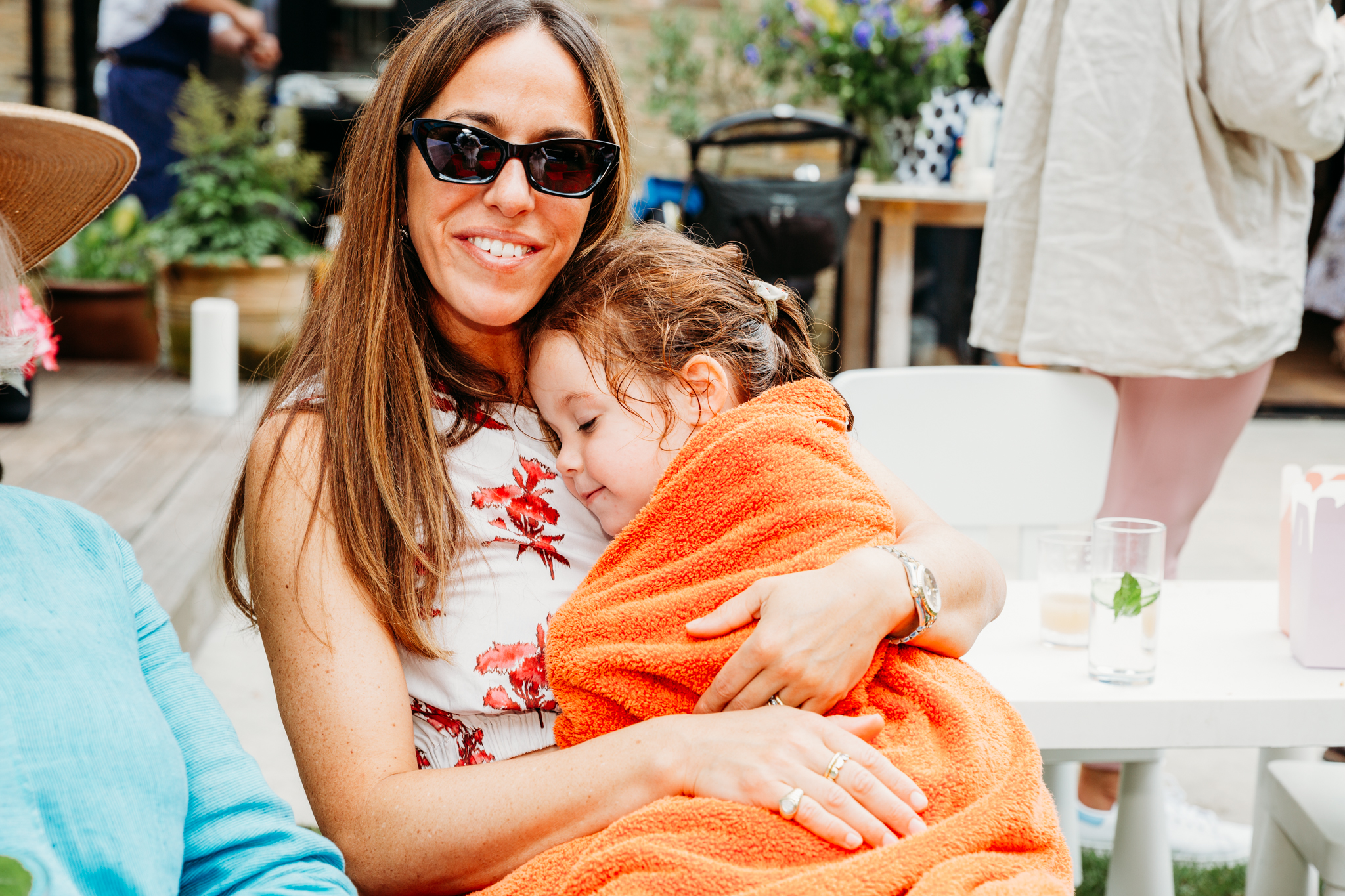 Mum holding her little girl in a towel.
