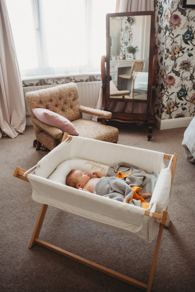 Newborn baby in his cot.