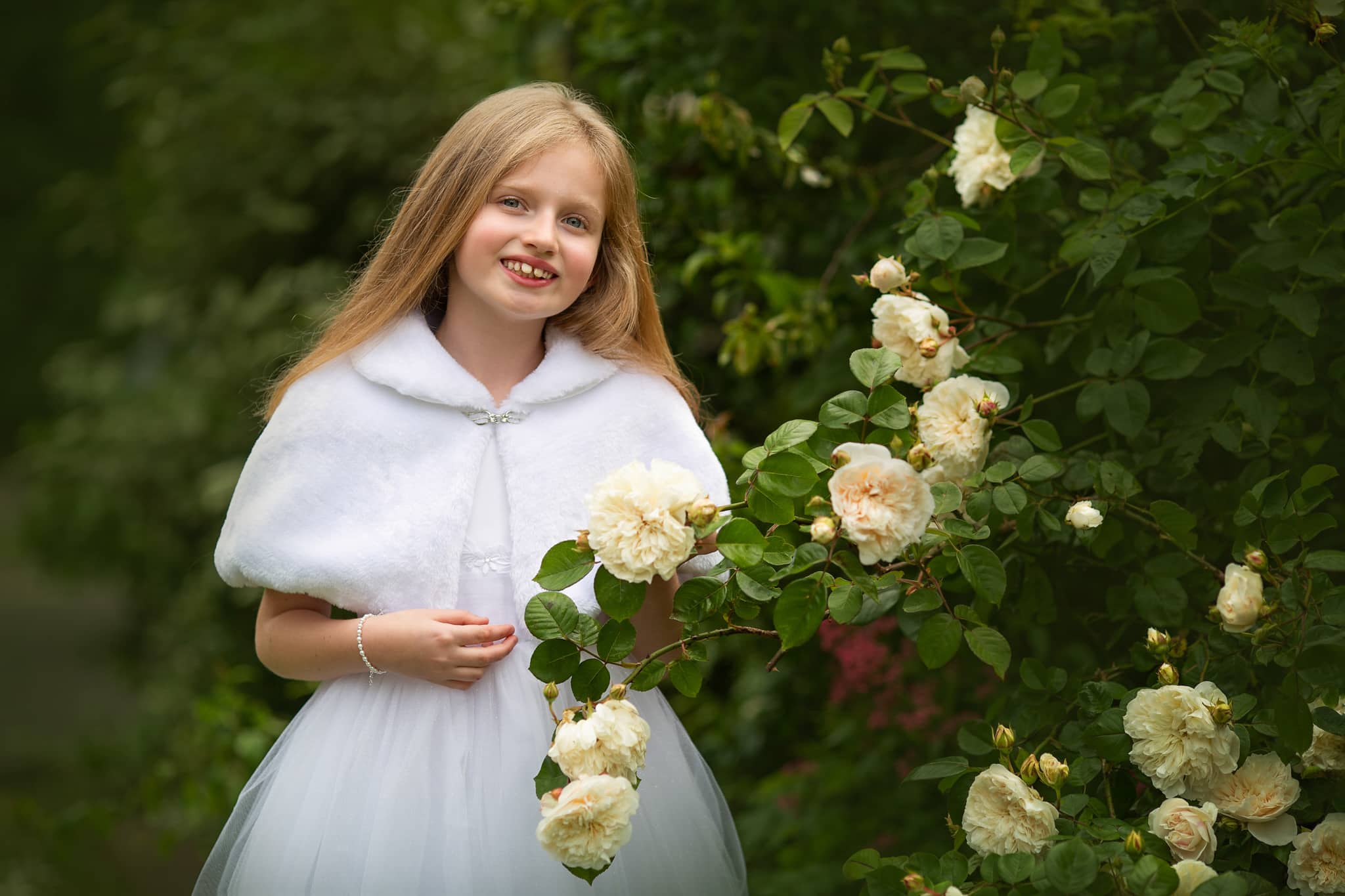 Christening photography London. Girl in white dress after her first communion.
